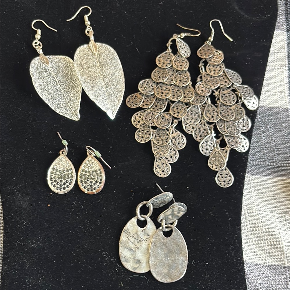 Four pair silver tone costume earrings